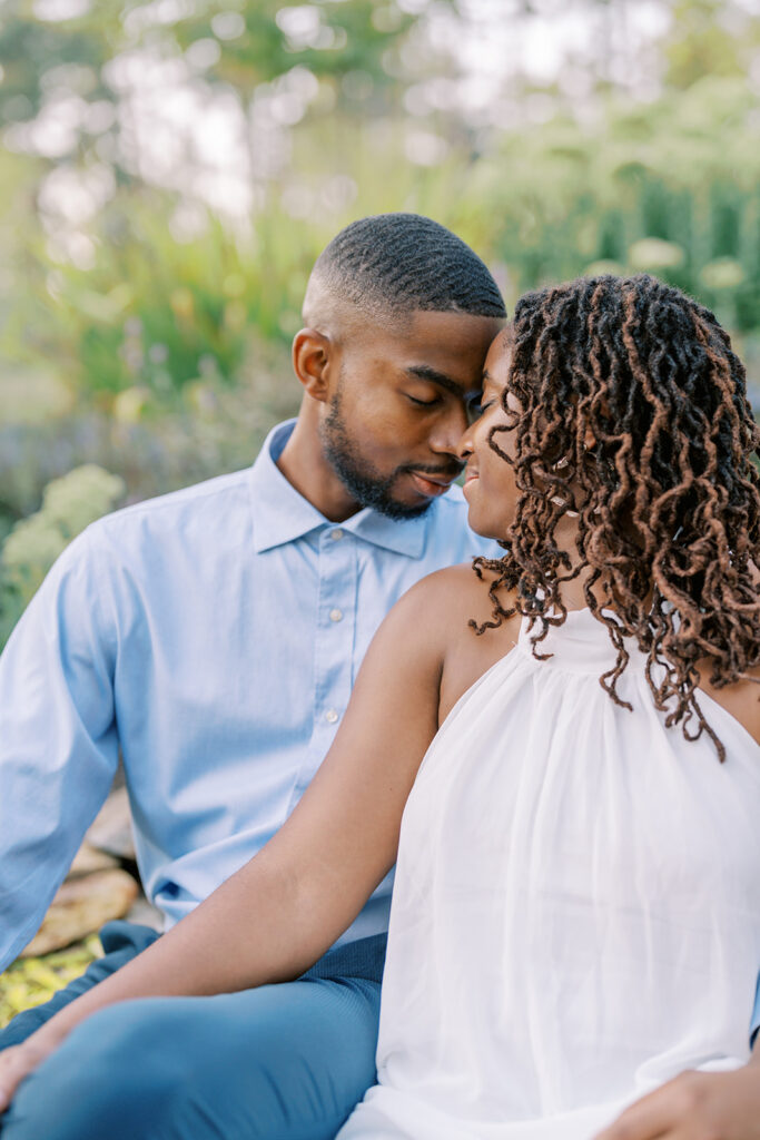 Agnes and Uzo share a joyful, laughter-filled moment together at Union Grove Barn in Chapel Hill, North Carolina, during their engagement session captured by North Carolina wedding photographer Jessica Leigh Mason.