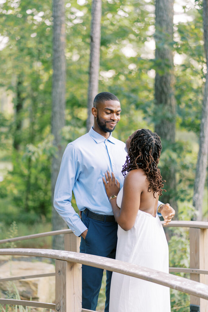 A close-up photo of Uzo gazing lovingly at Agnes while standing on the bridge over the creek at Union Grove Barn in Chapel Hill, North Carolina, captured by North Carolina wedding photographer Jessica Leigh Mason.