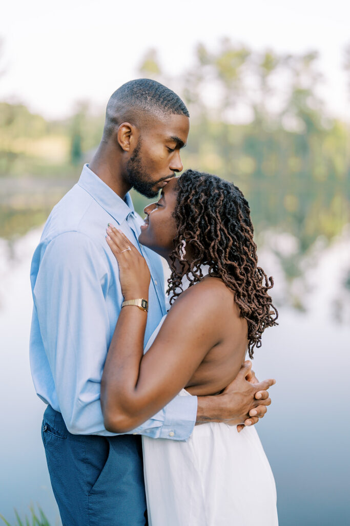 Agnes and Uzo hold each other close and look happily at the camera, sharing a joyful embrace during their engagement session at Union Grove Barn in Chapel Hill, North Carolina, captured by North Carolina wedding photographer Jessica Leigh Mason.