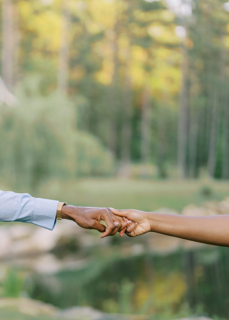 A close-up of Agnes and Uzo’s hands holding firmly together during their engagement session at Union Grove Barn in Chapel Hill, North Carolina, captured by North Carolina wedding photographer Jessica Leigh Mason.