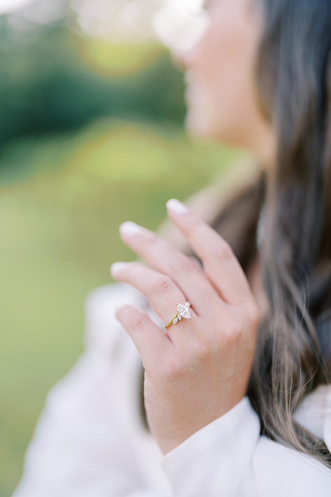 A close-up photo of the bride’s hand featuring her unique marquis-shaped engagement ring during a bridal session at The Vines of Lexington in South Carolina, captured by Durham wedding photographer Jessica Leigh Mason.
