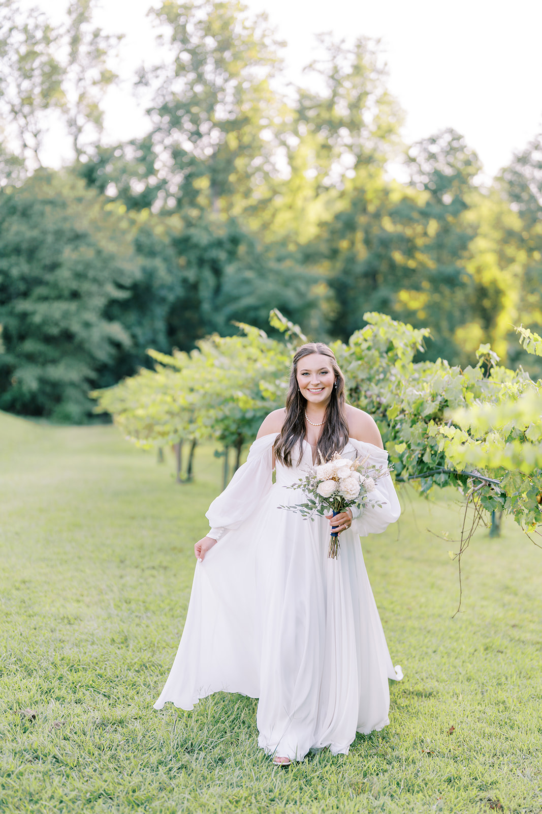 Cameron walks gracefully through the vineyard rows at The Vines of Lexington in South Carolina during her bridal session, captured by North Carolina wedding photographer Jessica Leigh Mason.