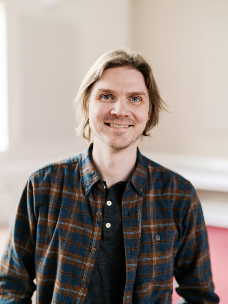 Professional headshot of a church administrative staff member in Raleigh, North Carolina, emphasizing competence and friendliness.