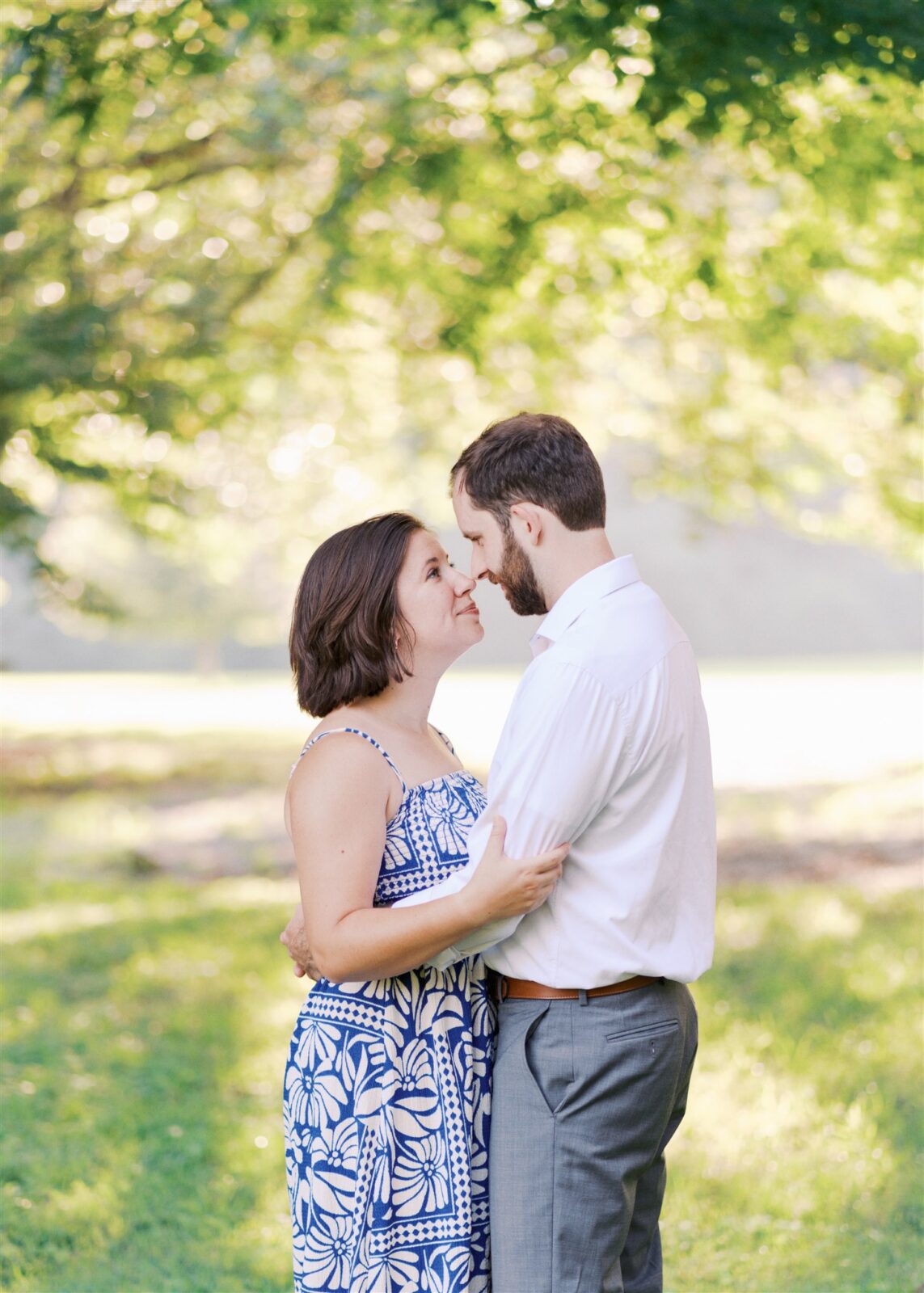Katie and Sam standing nose to nose during their anniversary photo session at Ayr Mount in Hillsborough NC, capturing a tender and romantic moment.
