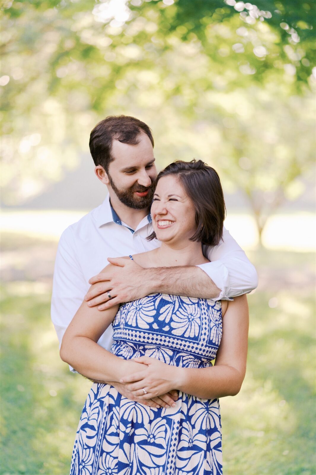 Katie and Sam making silly faces together during their anniversary photo session at Ayr Mount in Hillsborough NC, capturing their fun personalities.