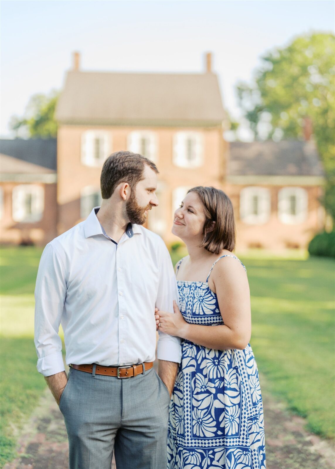 Katie and Sam posing for a portrait with the historic Ayr Mount house in the background during their anniversary photo session in Hillsborough NC.