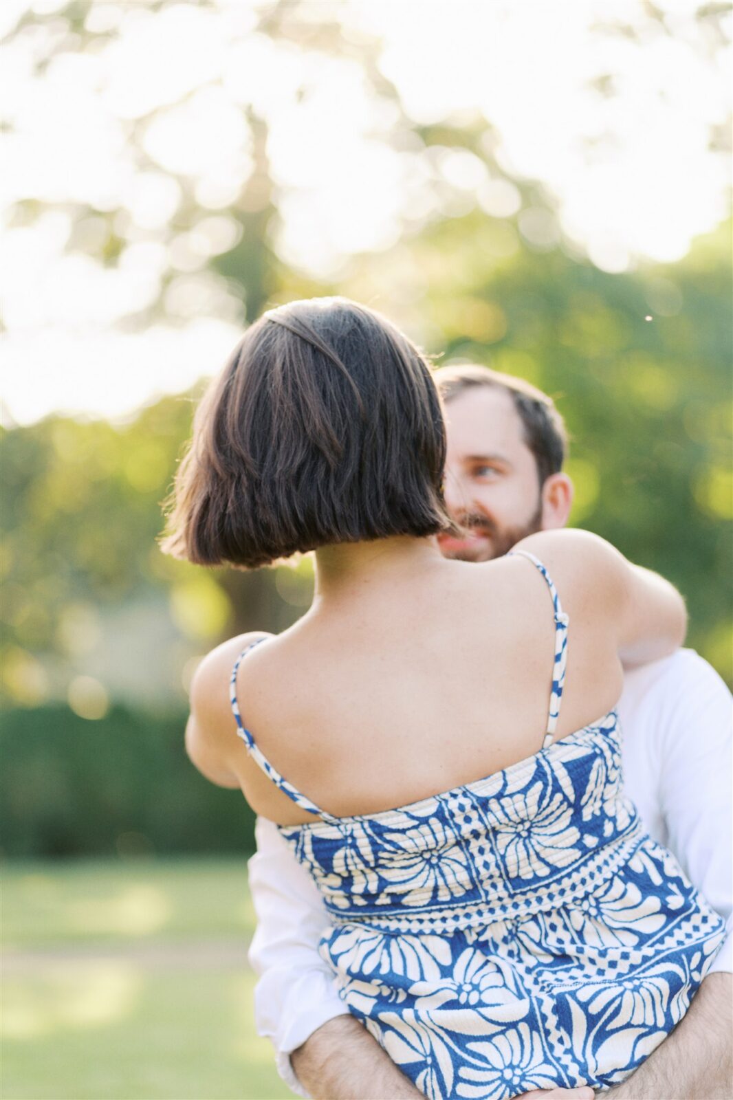 Sam spinning Katie during their anniversary photo session at Ayr Mount in Hillsborough NC, capturing fun hair movement and playful energy.