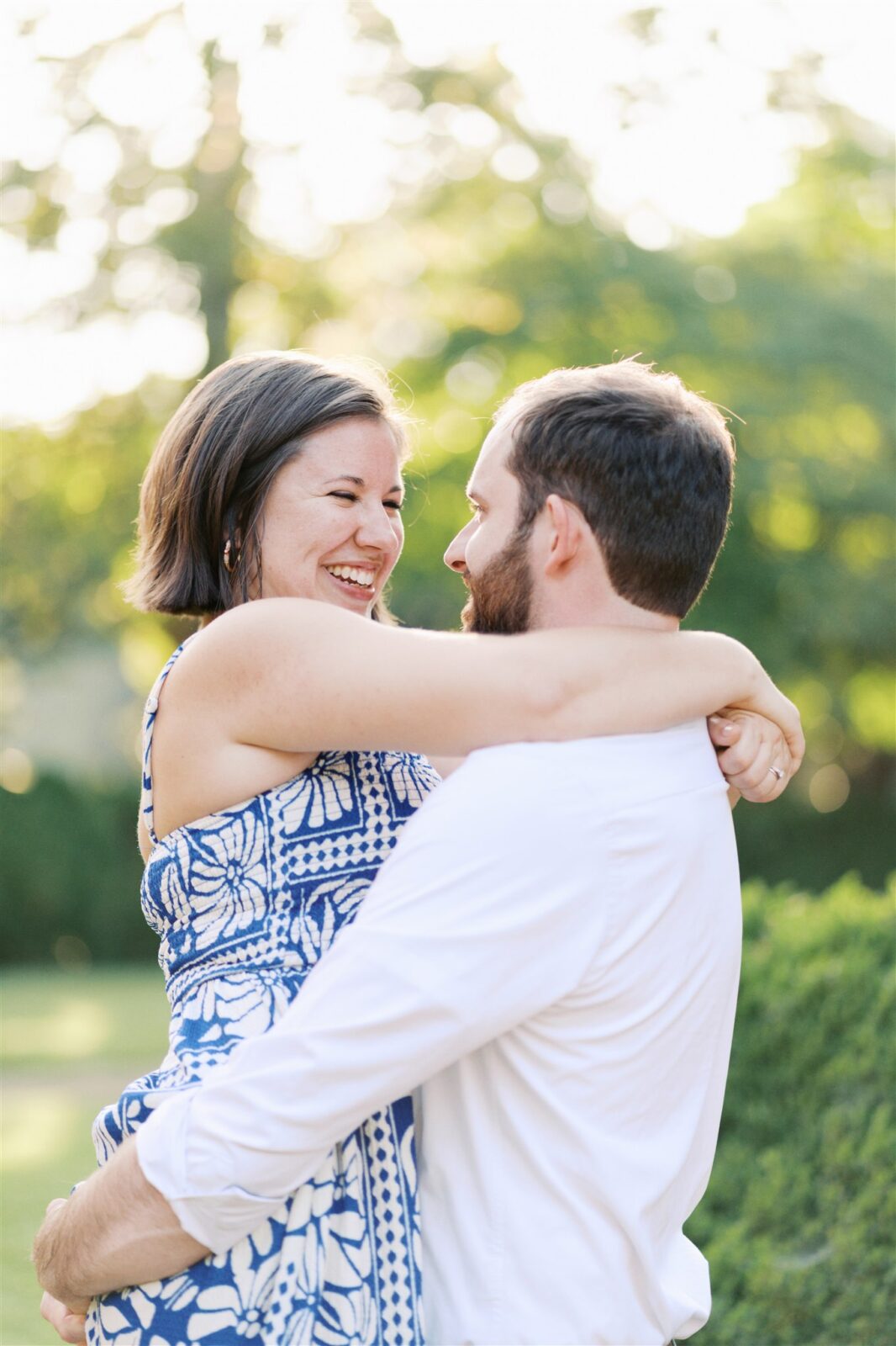 Sam carrying Katie during their anniversary photo session at Ayr Mount in Hillsborough NC, capturing a joyful and playful moment.