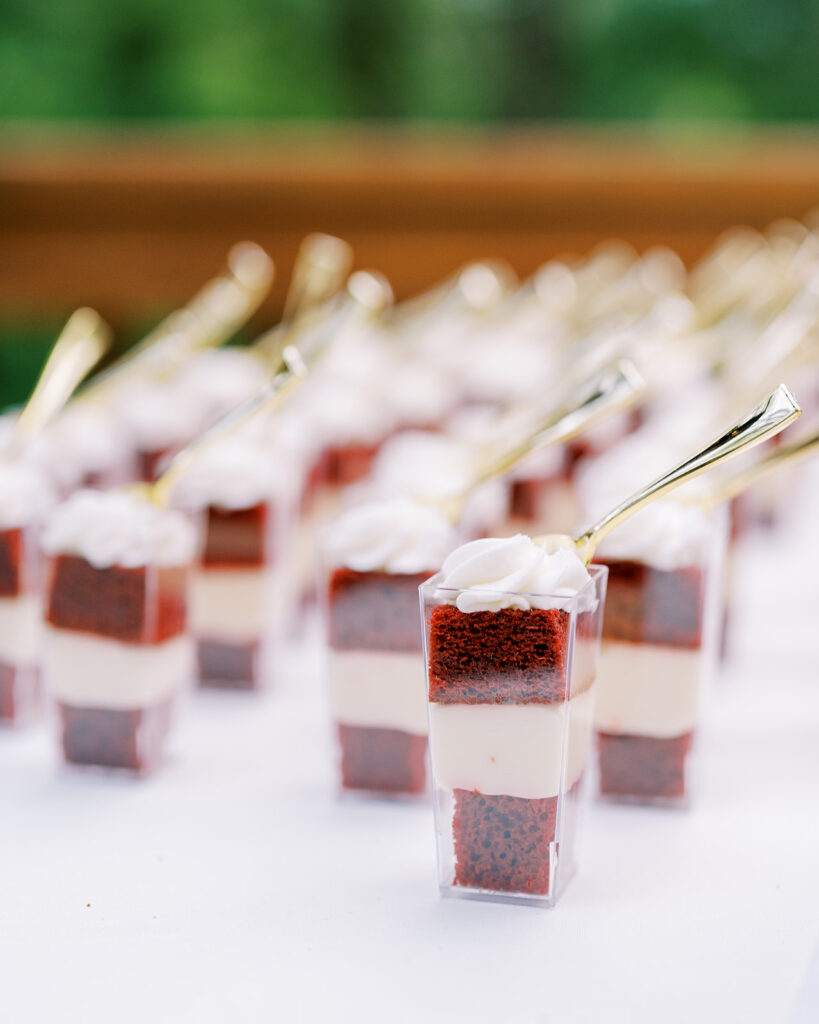 Wedding cake and red velvet mini cakes in dessert cups at River Landing wedding