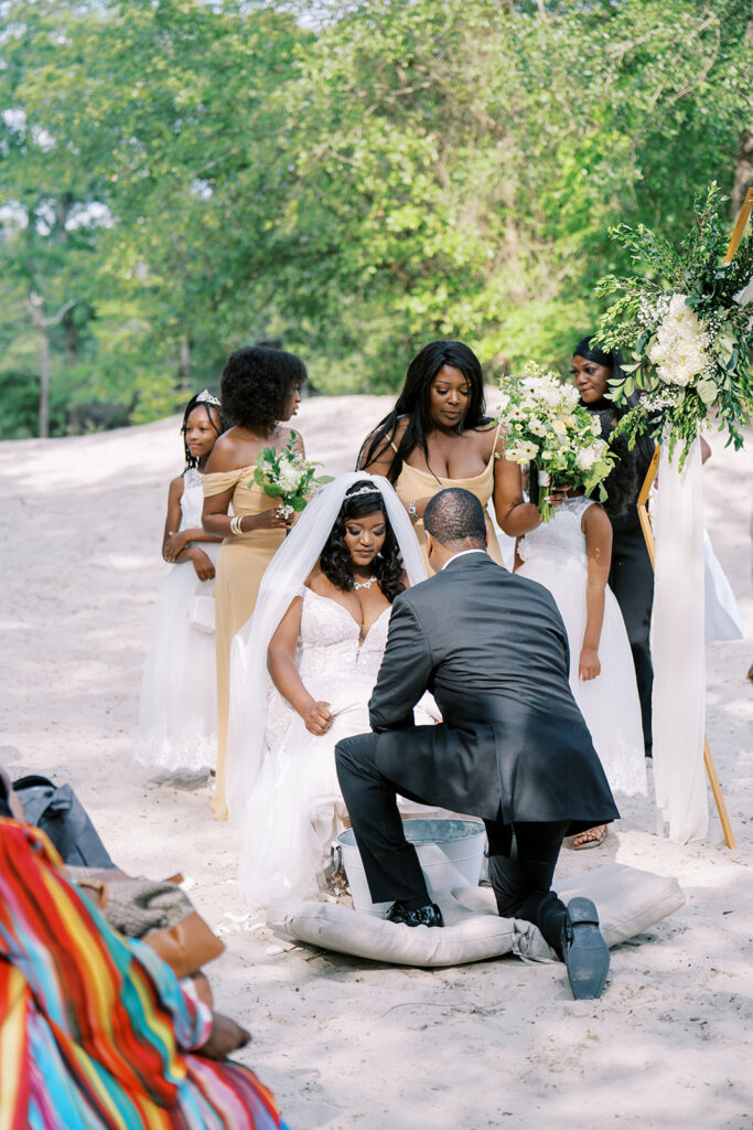 Bride and groom washing each other’s feet during a Christian wedding ceremony