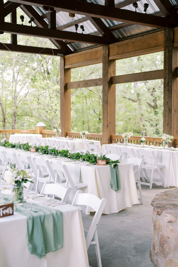 Beautiful wedding reception space decorated with florals and soft lighting at The River Lodge at River Landing