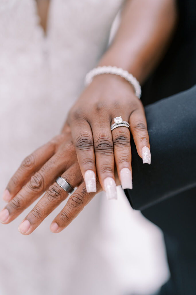 Bride and groom showing their wedding bands at their River Landing wedding