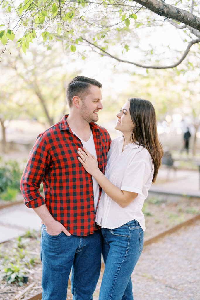 Candid moment of the couple laughing together in Romare Bearden Park, Charlotte