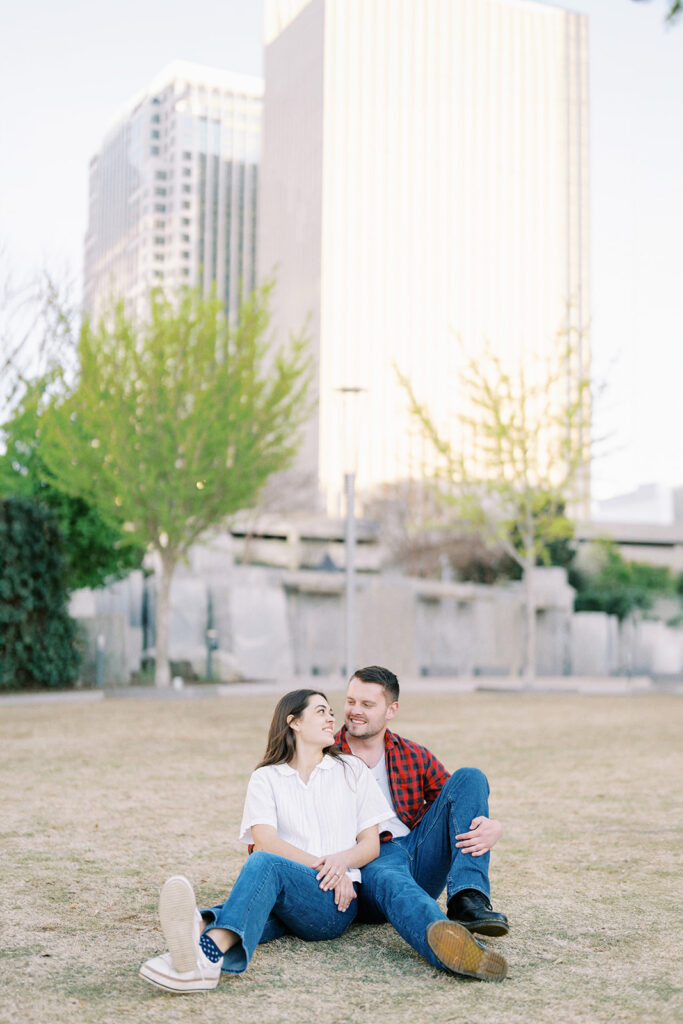 Romantic fine art portrait of Rachel and Nate, city skyline in soft focus behind them