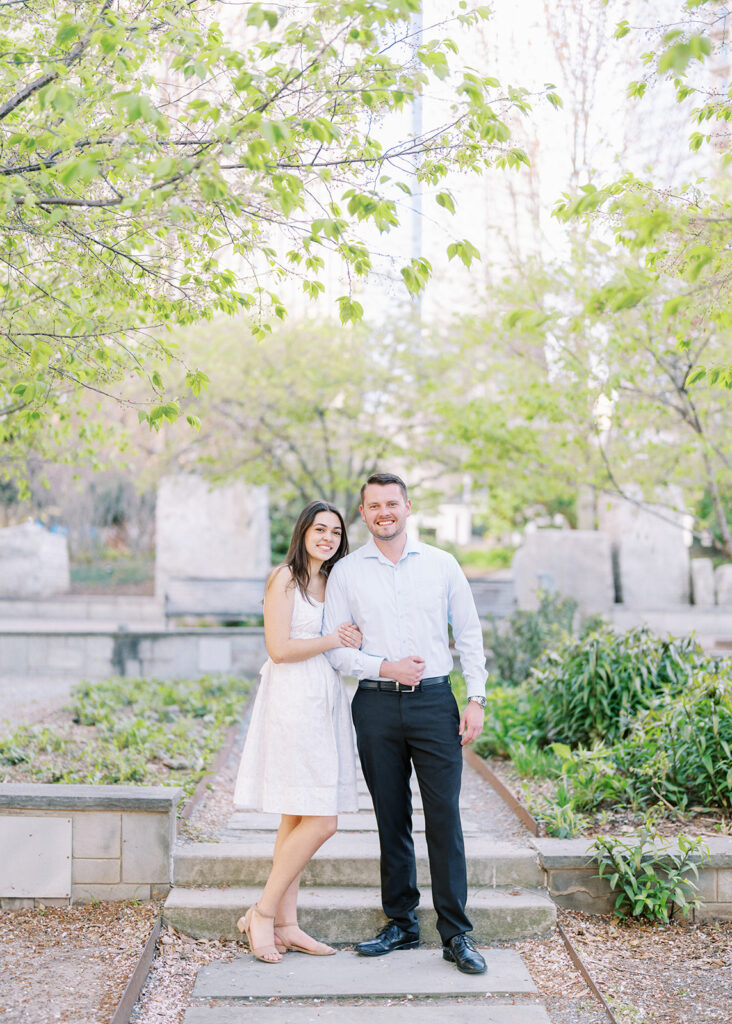 Elegant, light and airy engagement portrait of a couple at Romare Bearden Park in Charlotte, North Carolina during spring