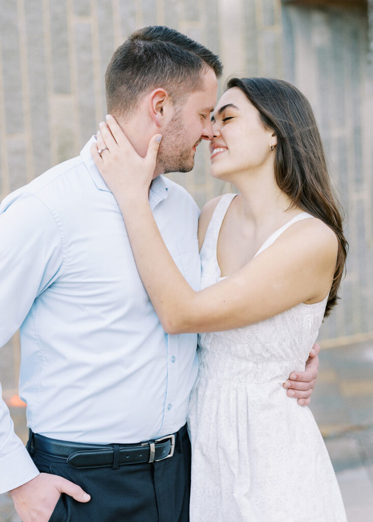Elegant fine art engagement portrait of a couple in uptown Charlotte, North Carolina with soft spring light