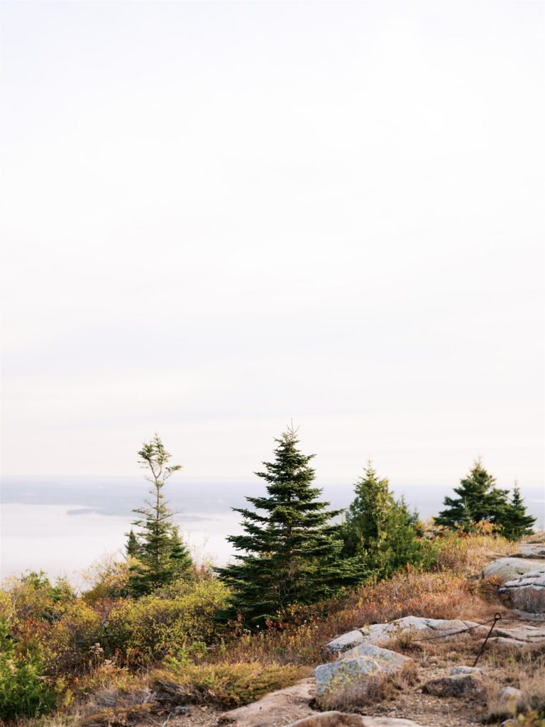 Cadillac Mountain shrouded in dramatic rolling clouds on an October morning in Acadia Maine

