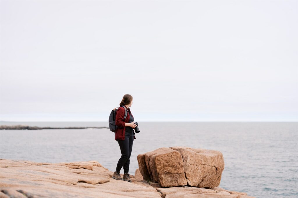 Photographer capturing the rugged coastline along the Park Loop Road in Acadia Maine
