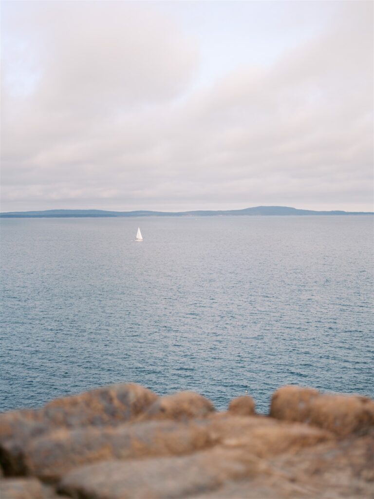 Sailboat on the calm Atlantic waters off the coast of Acadia Maine
