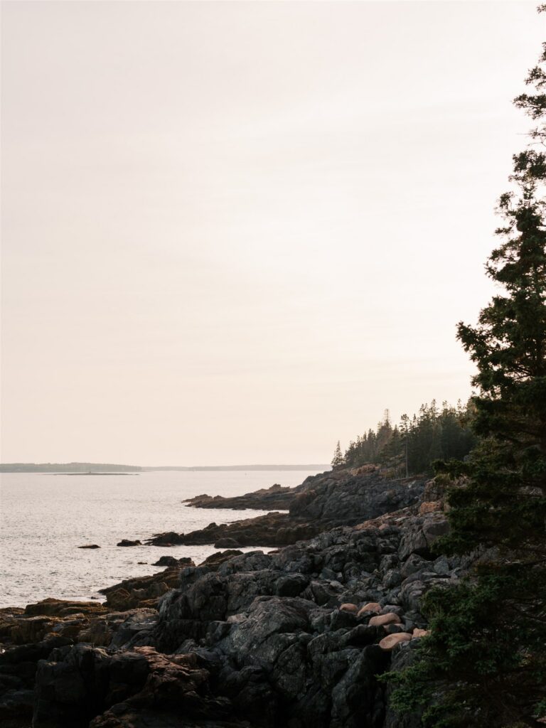 Sunset over Little Hunters Beach with soft light reflecting off the rounded pebbles in Acadia Maine
