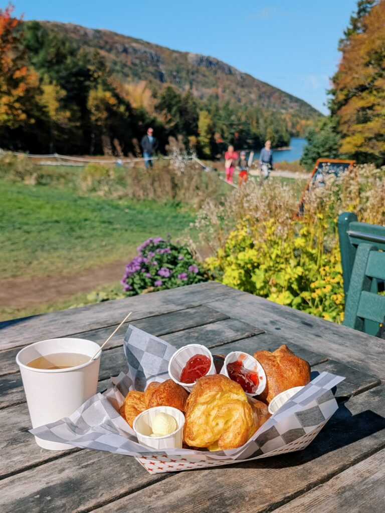 Fresh popovers at Jordan Pond House with fall flowers and autumn colors in Acadia Maine
