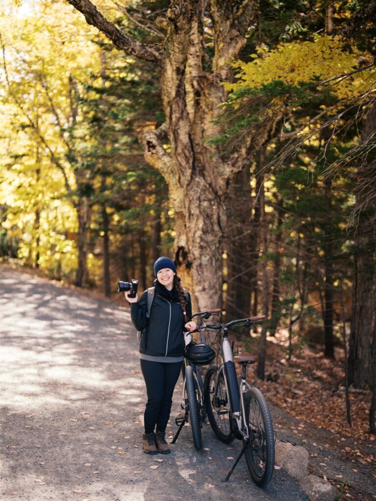 Photographer with camera and electric bikes outside Jordan Pond House in Acadia Maine

