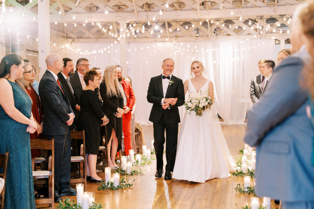 Bride making her entrance down the aisle in a cozy industrial wedding venue in downtown Raleigh