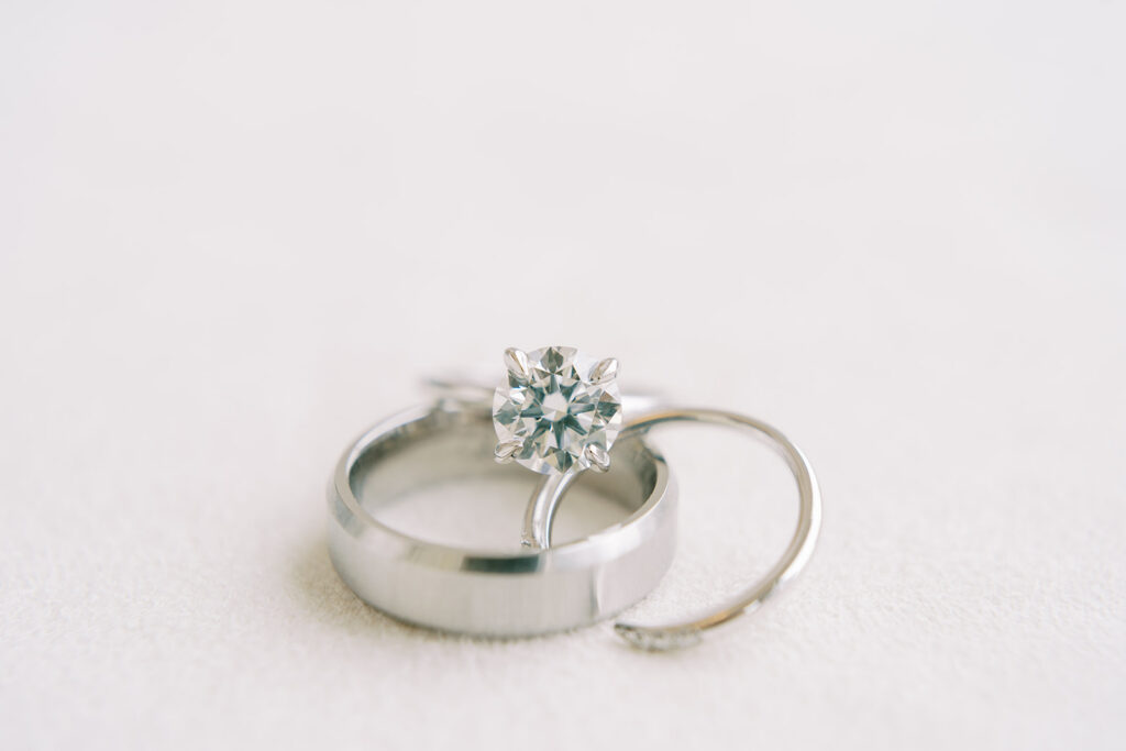 Macro shot of wedding bands featuring a sparkling diamond ring and a contemporary open-style white gold band