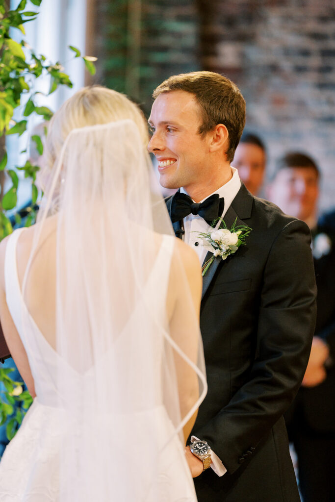Bride and groom standing together during a heartfelt wedding ceremony