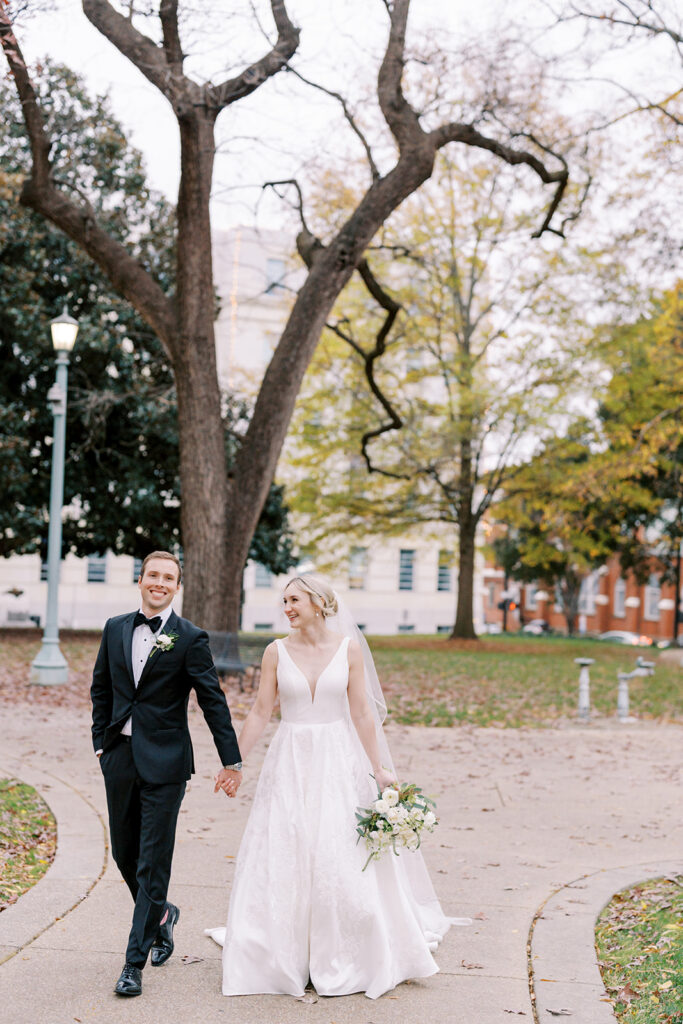 Bride and groom standing outdoors at the Capitol grounds during a winter wedding session