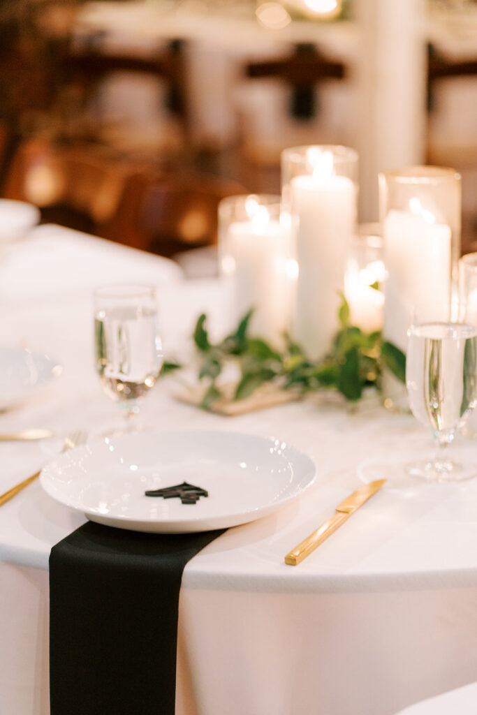 Elegant wedding table setting with custom name cards and black napkins