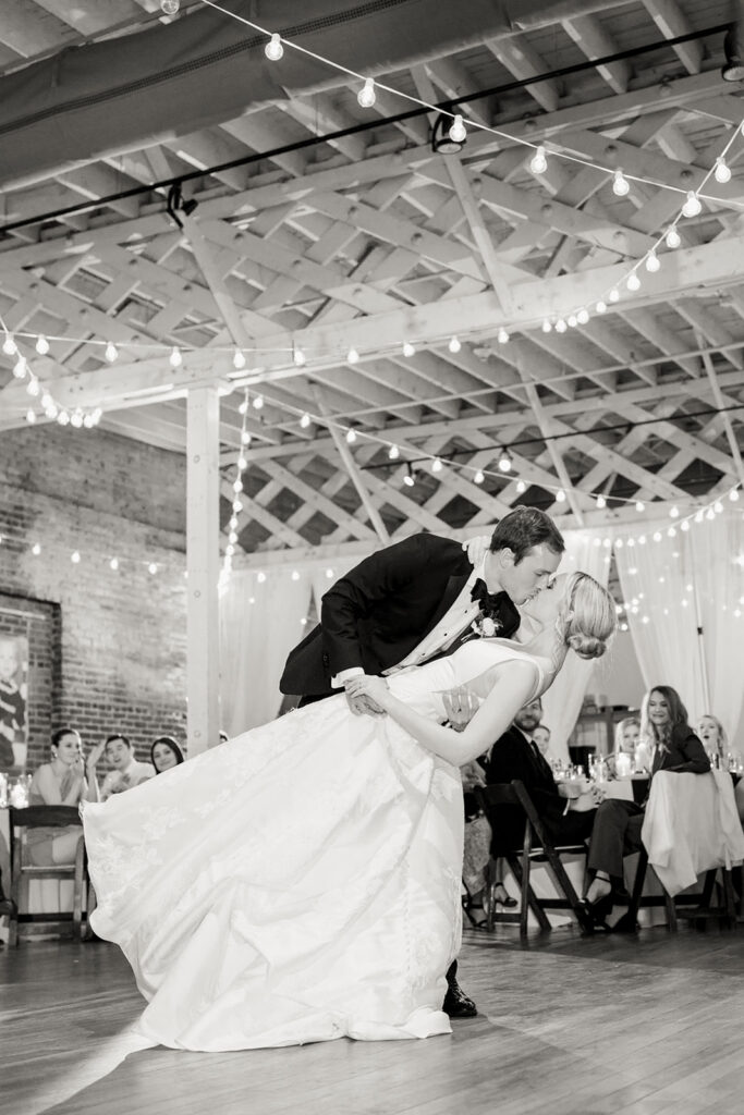 Bride and groom sharing a dip kiss during their first dance at Stockroom 230