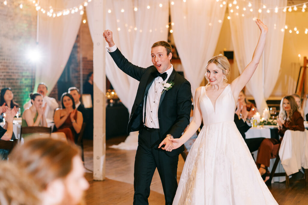 Bride and groom making their grand entrance into the wedding reception