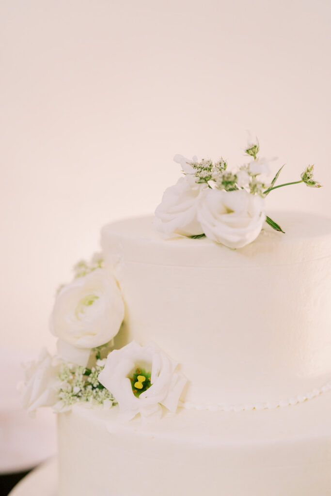 Wedding cake decorated with delicate floral details at the reception