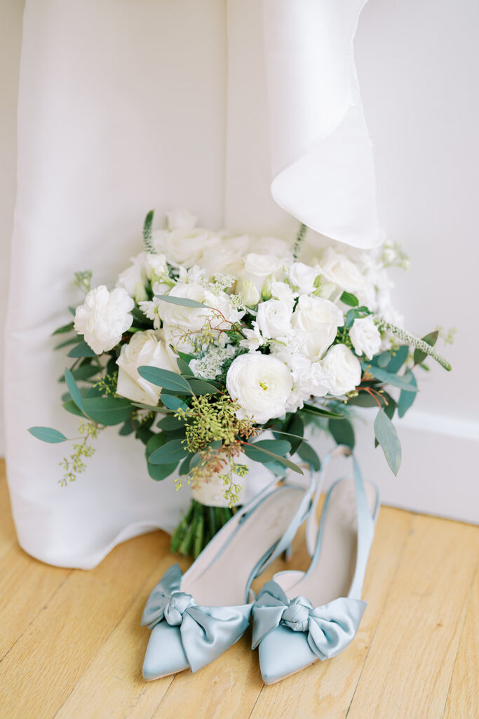 Bridal bouquet and blue wedding shoes photographed in natural light at The Glass Box