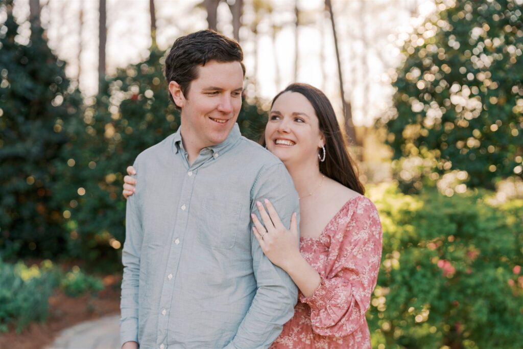 right and joyful portrait of expecting couple together at WRAL Azalea Gardens Raleigh NC during spring maternity session