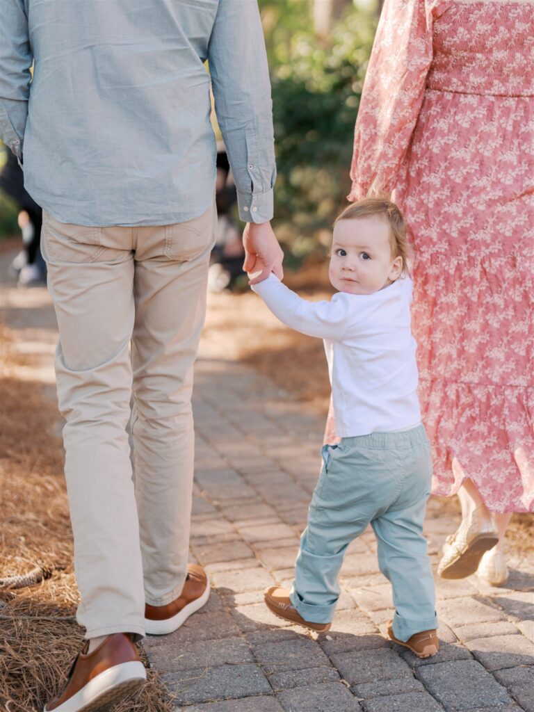 Toddler walking along the path at WRAL Azalea Gardens during spring family session in Raleigh NC