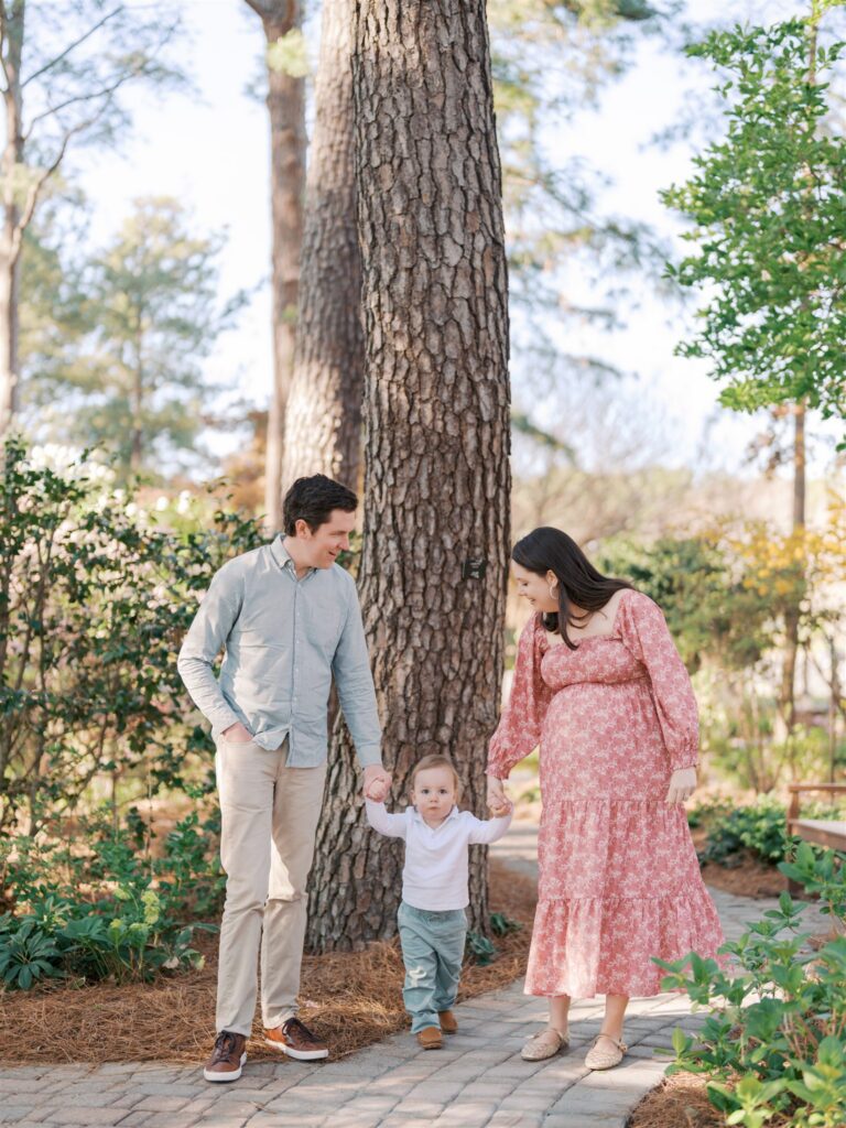 Family walking hand in hand together along the path at WRAL Azalea Gardens Raleigh NC