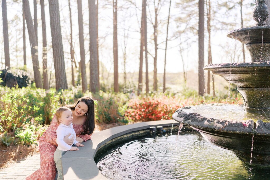 oddler mesmerized by the fountain at WRAL Azalea Gardens in Raleigh NC during spring family session