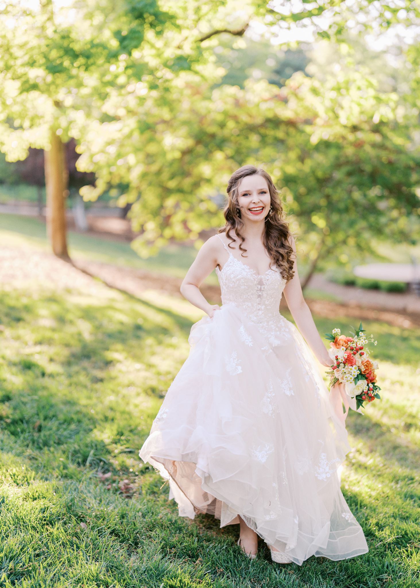 Spring bridal portrait featuring a bride walking through lush greenery in soft natural light