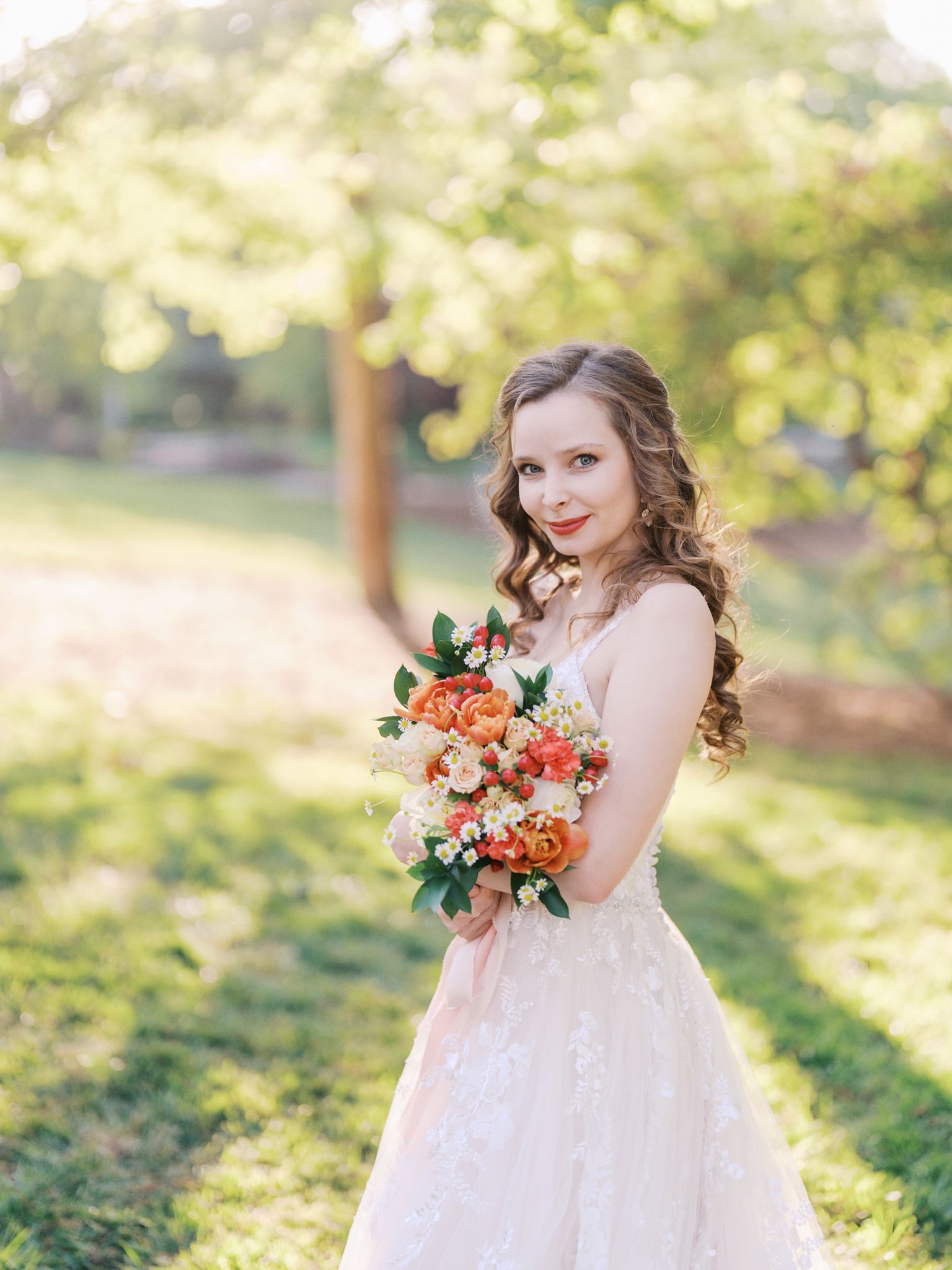 Intimate bridal portrait with colorful flowers and soft spring light in a garden setting
