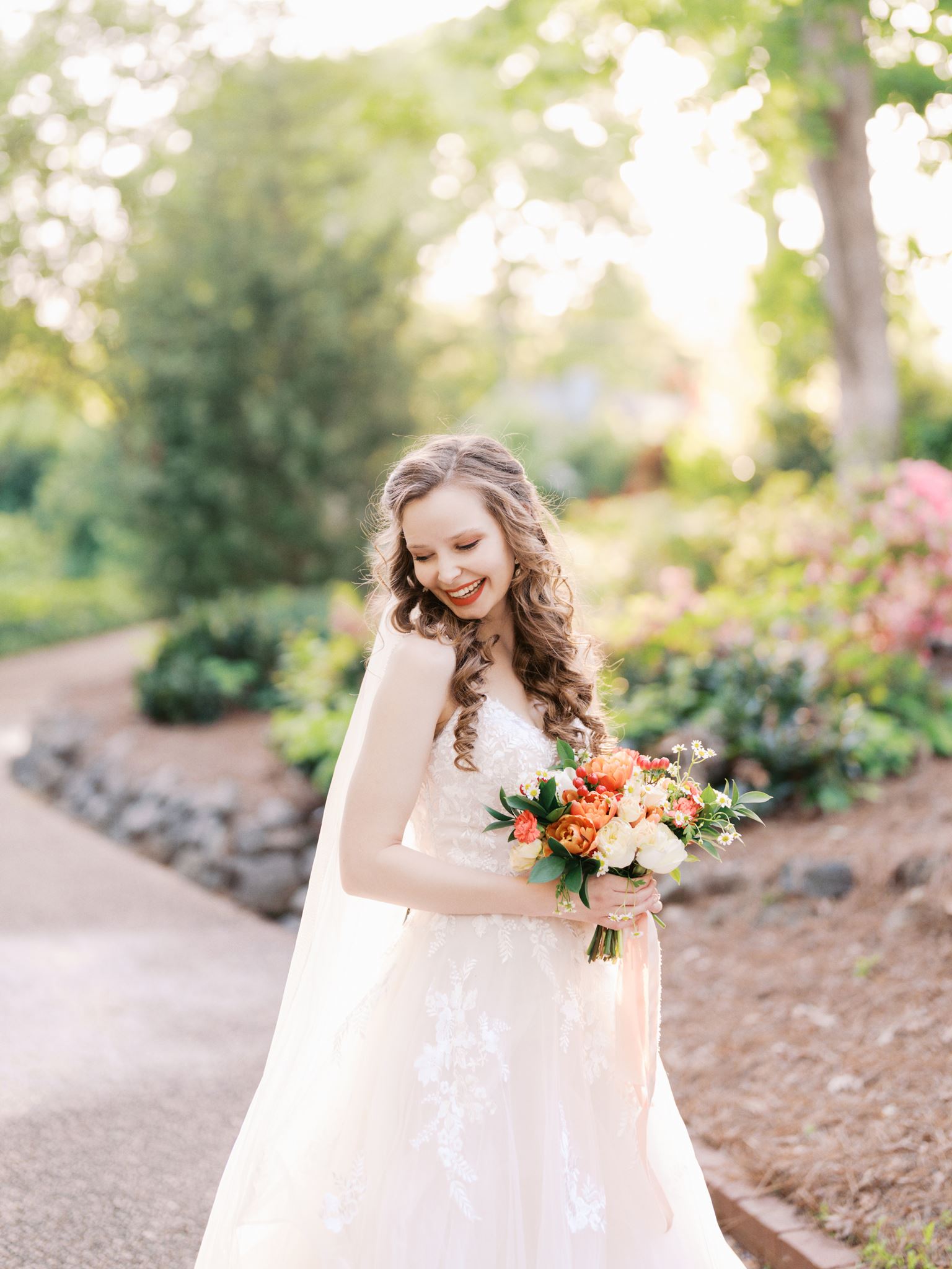 Bride looking over her shoulder in an intimate spring bridal portrait at Glencairn Garden in Rock Hill, SC