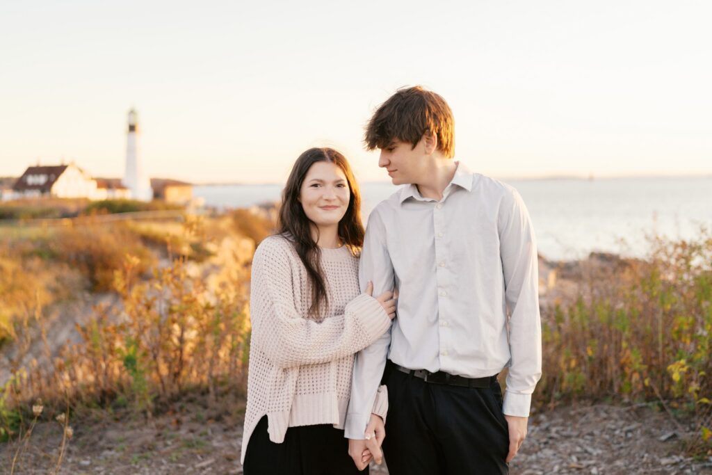 Romantic close-up of high school sweethearts during a sunrise engagement session in Cape Elizabeth, Maine