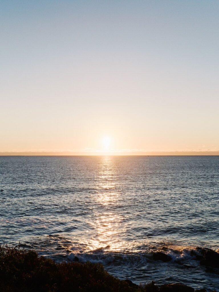 Sunrise over the Atlantic Ocean during a Portland Head Light engagement session on the Maine coast