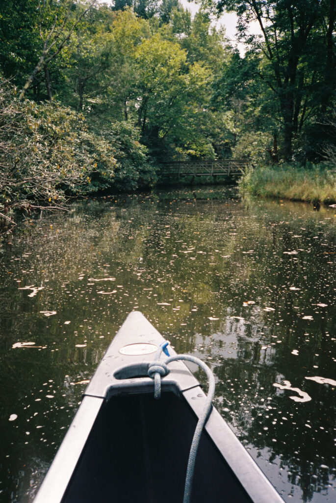 Canoe on Price Lake near a covered area and bridge, Boone, NC