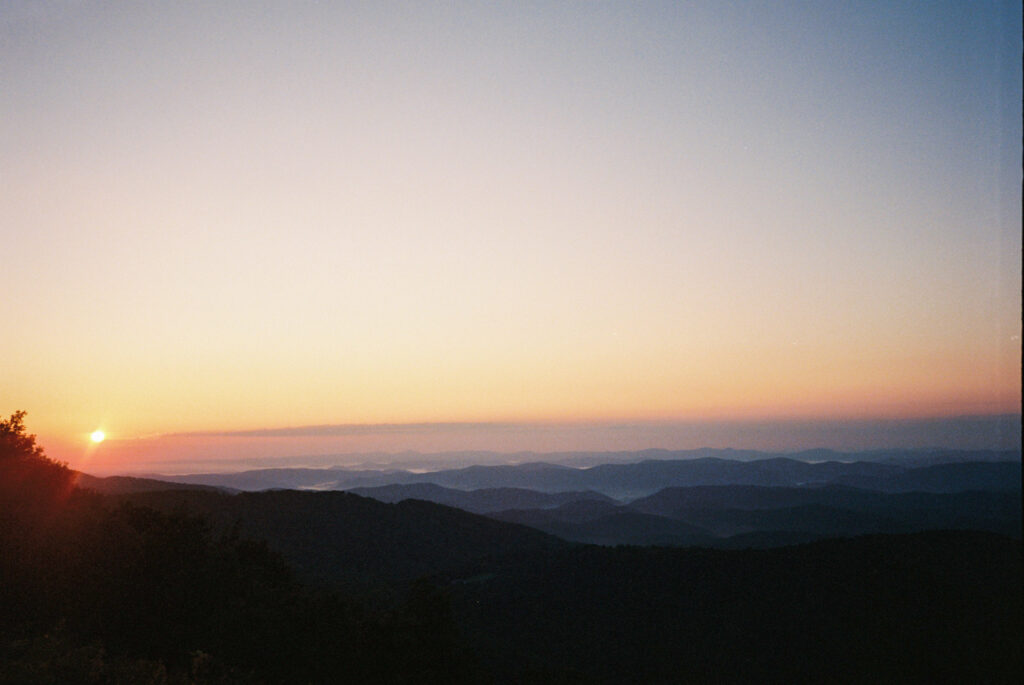 Sunset over the Blue Ridge Parkway seen from the back of a car